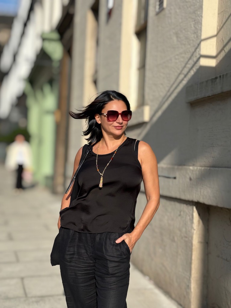 Eteri McKenzie walking confidently on a sunny Edinburgh street, symbolising forward movement and brain transformation through solution-focused hypnotherapy.
