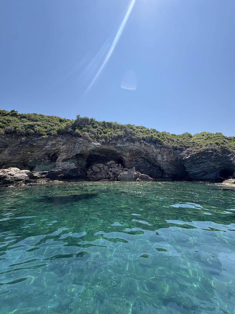 Crystal-clear turquoise water near a rocky cave, symbolising calm and clarity beyond fear.
