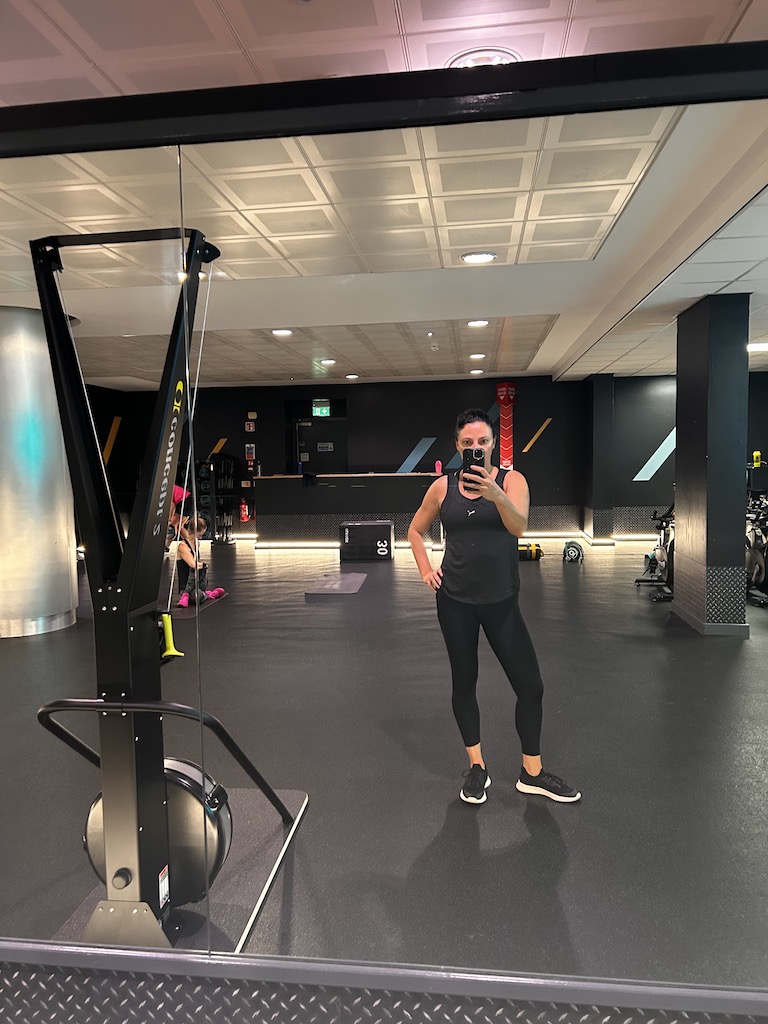 Eteri McKenzie standing in a gym, showing how anxiety can manifest physically through posture, tension, and body awareness.